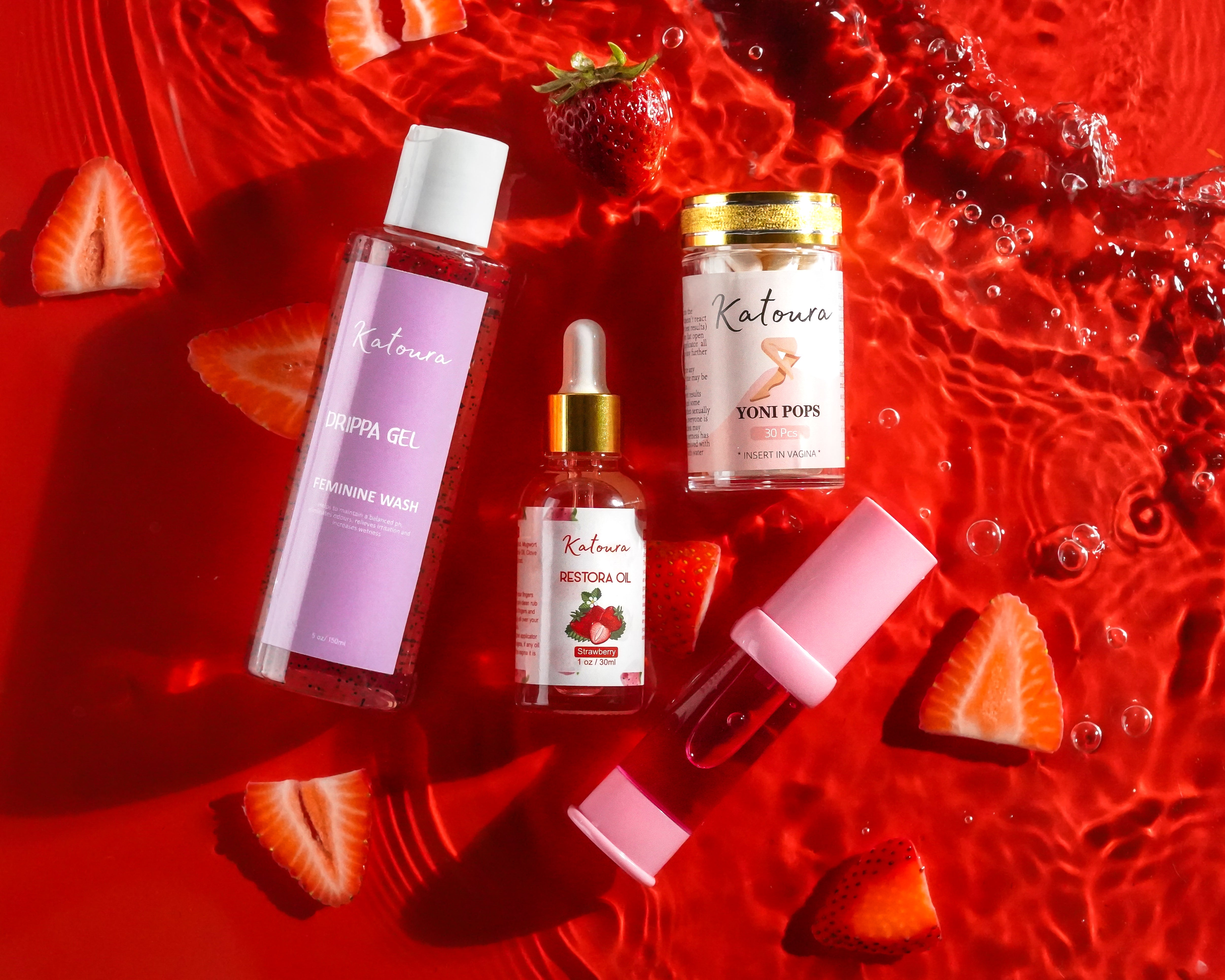 Beauty products with strawberries on a red watery background.